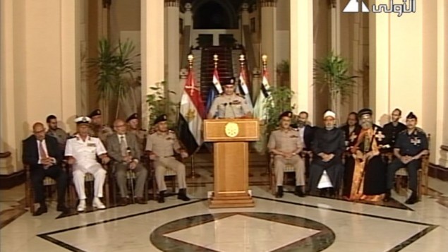 Lt. Gen. Abdel-Fattah al-Sisi, center, flanked by military and civilian leaders in including reform leader Mohamed ElBaradei, far left, Tamarod leader Mahmoud Badr, second left and Pope Tawadros II, second from right, as he addresses the nation on Egyptian State Television Wednesday, July 3 (photo credit: AP/Egyptian State Television)